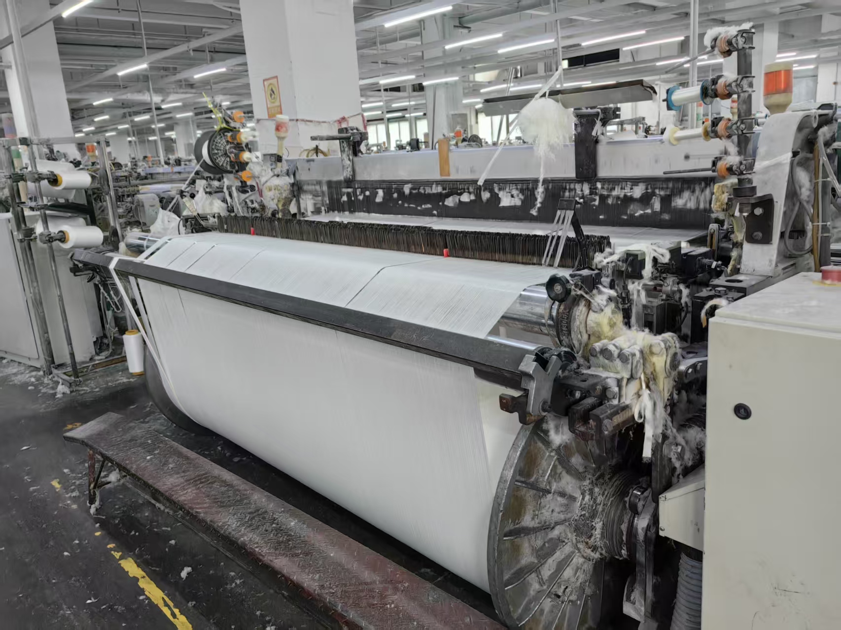 Full view of the grey fabric weaving workshop floor